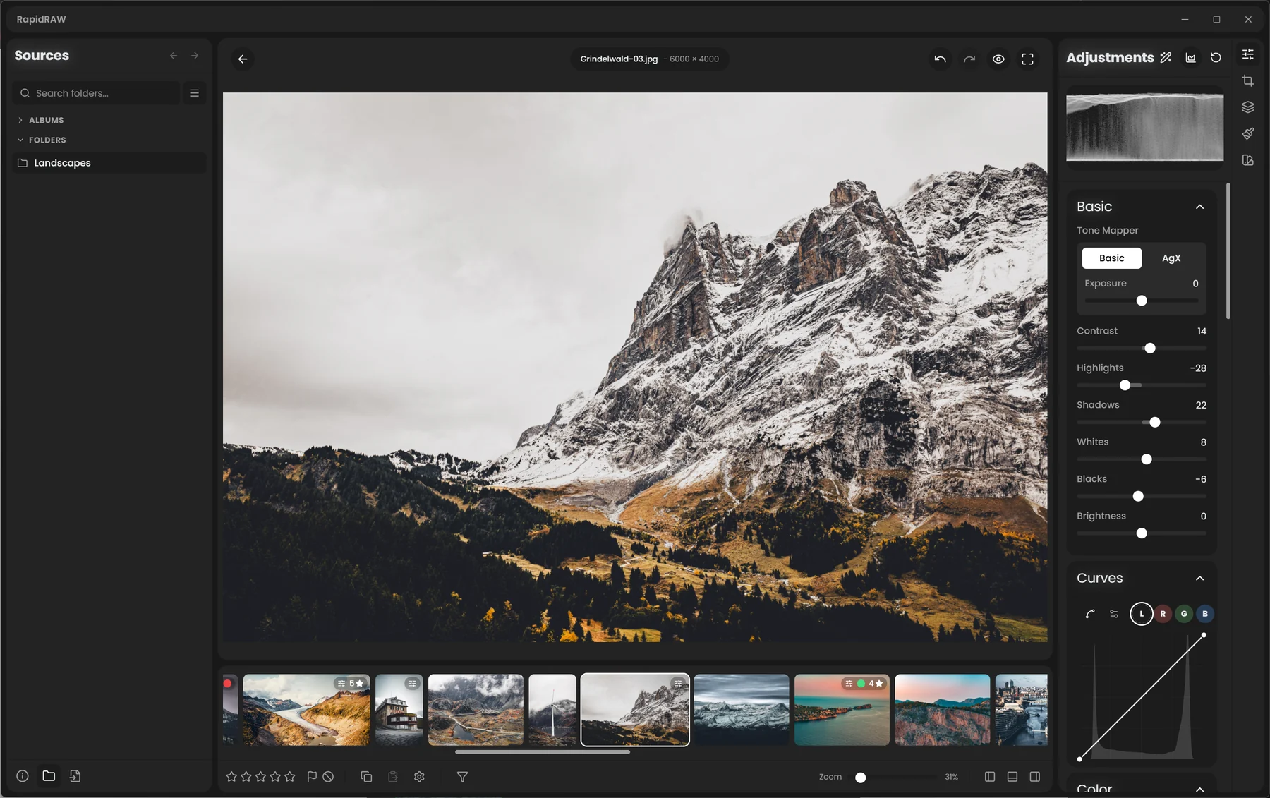 RapidRAW editor with a mountain photo, the Sources panel on the left and the Adjustments panel on the right